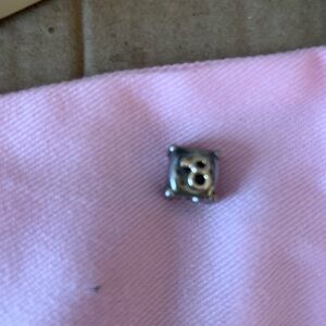 Pandora retired 2 rings on pillow charm.  Sterling